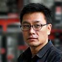 Hiroshi Tanaka, chief performance technician, meticulously adjusting suspension on a race car.